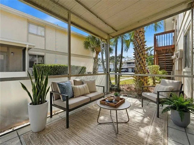 Screened patio with a covered ceiling, tile flooring, and a low-pile area rug