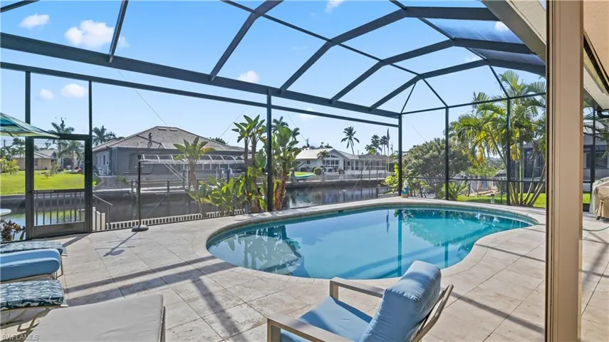 Double picture windows maxumize the views outdoors - SOUTHERN EXPOSURE ***** NO BRIDGES *** Corner Lot with parking for larger/longer/multiple boats!    Sparkling pool and plenty of outdoor space - both shaded and in the sun!