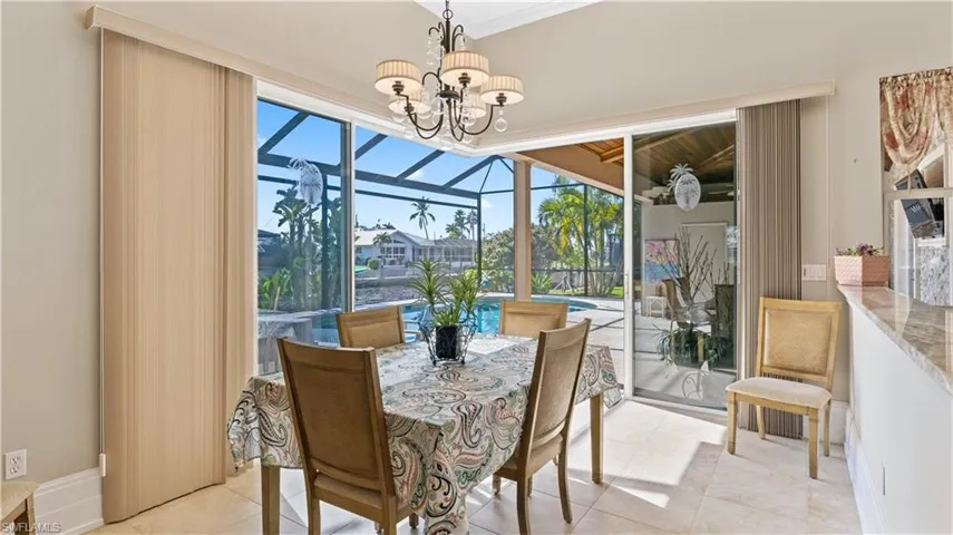 Dining room is located off the kitchen and can easily accommodate a large table - the glass doors are 90 degree sliders and can be opened to extend the living area - this home really offers so much for entertaining reasons!  Kick back with friends and family and enjoy the good life!