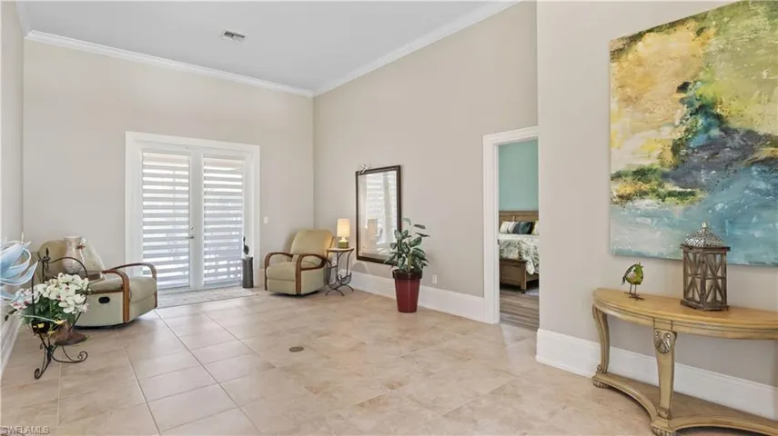Double door foyer welcomes you into this additional living space that looks out onto the patio.  More beautiful designer shades, and electrical floor outlet with plenty of space.