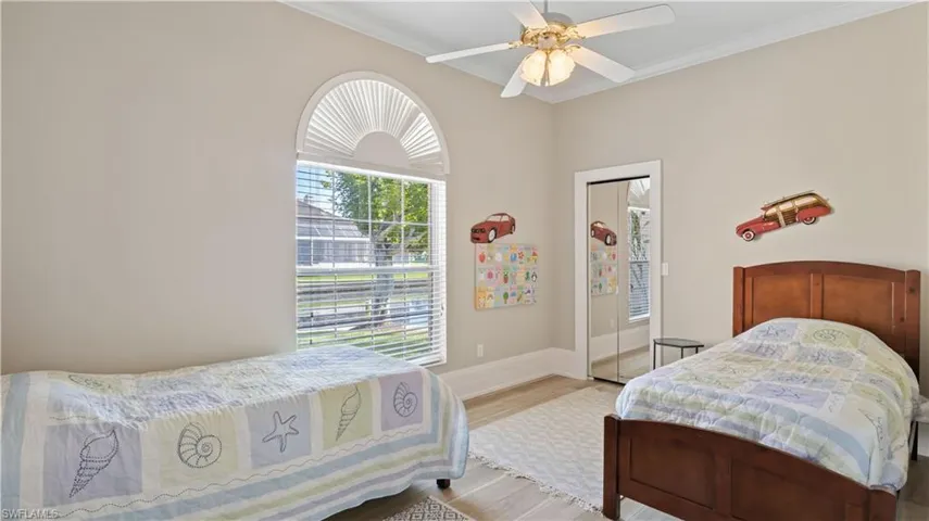 Another oversized bedroom with plenty of room for multiple furniture configuarations!  Light, bright and airy and split from the master bedroom, this side of the home features two spacious bedrooms, tall ceilings and a full bath with access to the pool area!