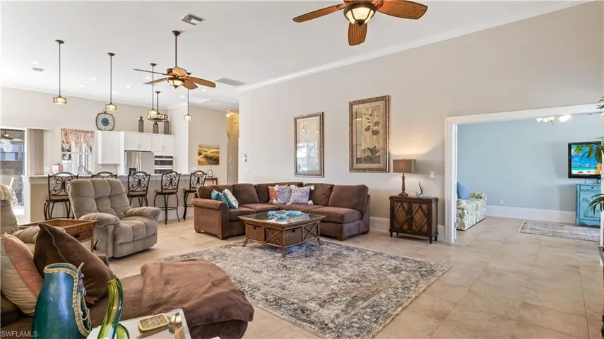 View from the family room into the kitchen - the ceiling heights are 12 foot and higher making the home seem even larger than it is, and while always having a light and bright open concept!