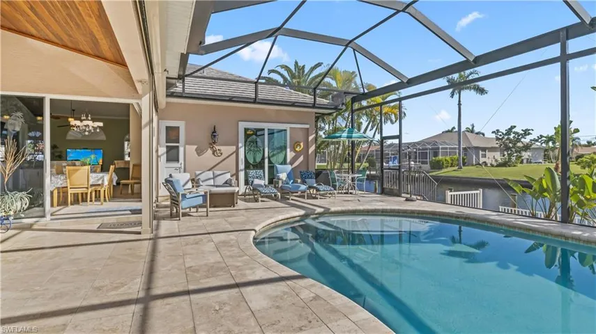 Kavalar electronic shutters shade the entire back lanai under truss!  Travertine tile and beautiful pool coping add to the entire outdoor look!