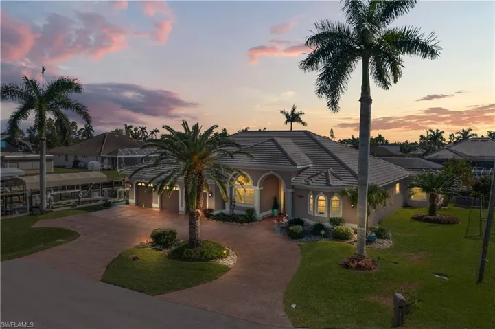 Circular drive and beautiful lush landsape welcome you to this estate home with BRAND new roof and located in the heart of the Southwest Cape with easy access to EVERYTHING including shopping, bike and walking paths, Tarpon Point and Cape Harbor among others.  South facing with the best sun exposure and gorgeous sunsets, all wrapped around an intersecting canal with plenty of room for large / multiple boats.  This home recently underwent a MAJOR renovation with Koogler Homes after  Hurricane Ian.