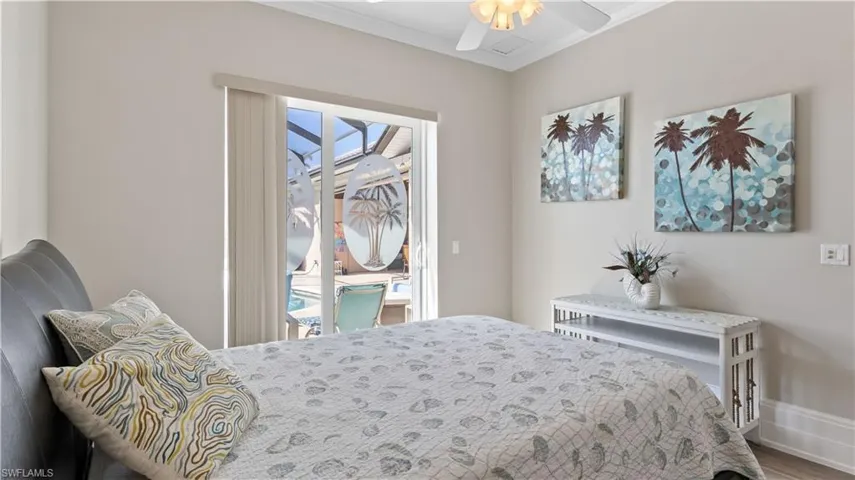 Third bedroom with double sliders to the outside pool area - 11 inch baseboards throughout the home, beautiful new flooring and those views!!!!!!!!!!!!!!!
