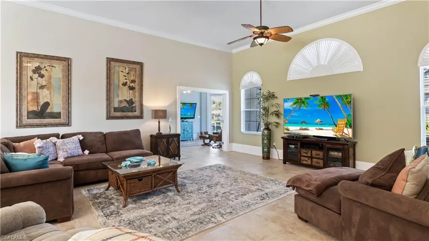 Family room looking into the media room with its own private entrance - travertine tile and an accent wall create a neutral and peaceful ambiance!  Every inch was used to create a large, functional yet fun living space!  Over 3,200 square feet and even a HIDDEN SAFE ROOM/HURRICANE ROOM - can you guess where it may be?