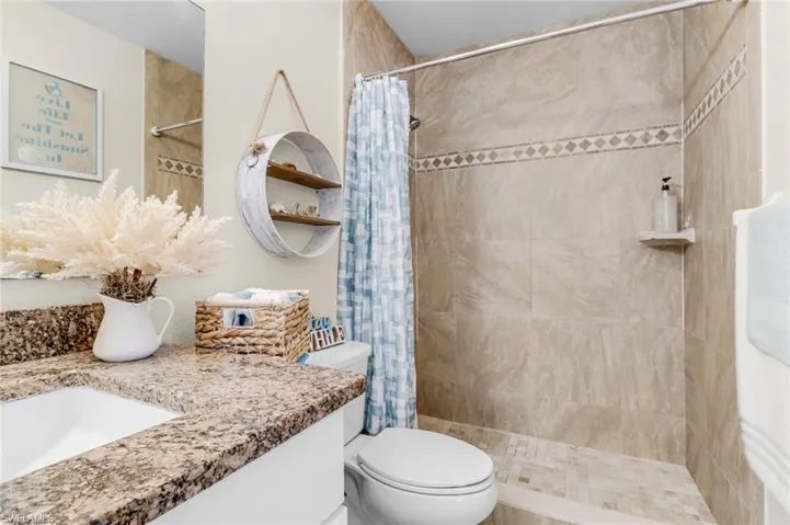 Full bath with vanity and a shower stall