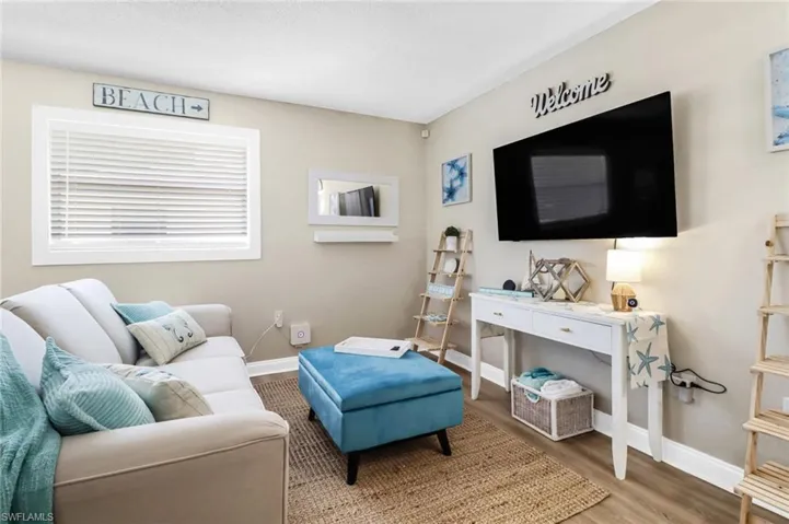 Living area featuring baseboards and wood finished floors