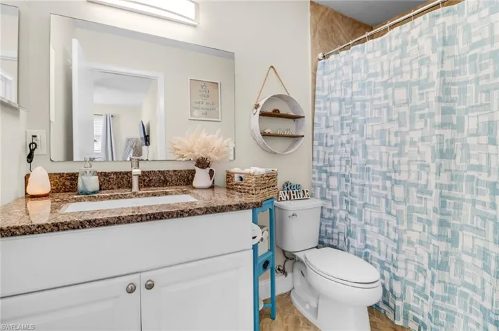 Bathroom with vanity and curtained shower