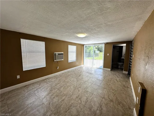 Master bedroom with slider to back yard and driveway.