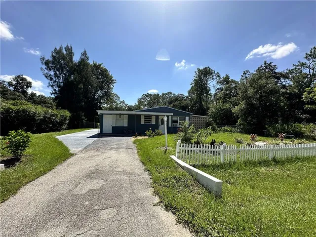 Single story home with white picket fence