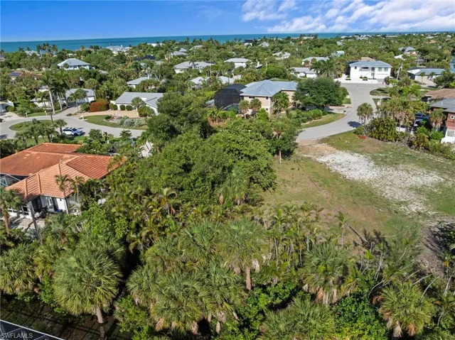 Expansive undeveloped lot featuring partial tree coverage and clear areas