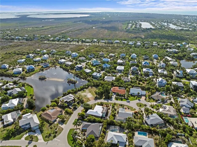 Aerial perspective showcasing a residential community with water features
