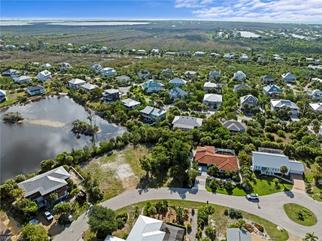 Residential community featuring diverse architectural styles, mature landscaping, and a natural water feature