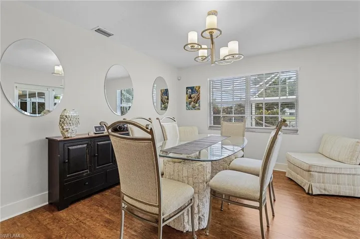 Dining space featuring a chandelier and hardwood / wood-style flooring