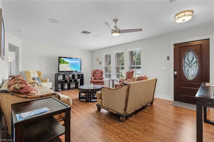 Living room featuring hardwood / wood-style flooring and ceiling fan
