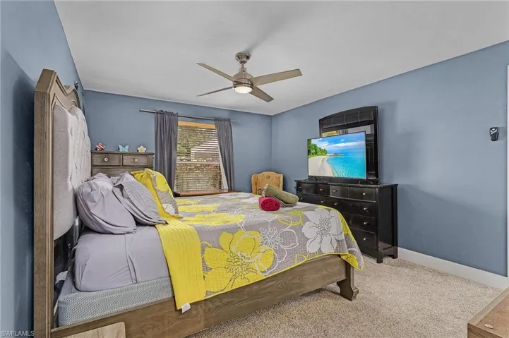 Carpeted bedroom with ceiling fan