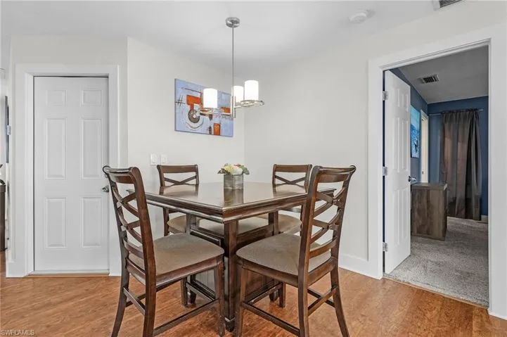 Dining space with a notable chandelier and light wood-type flooring