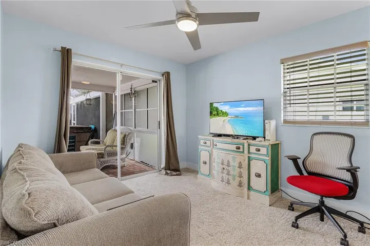 Living room with carpet and ceiling fan