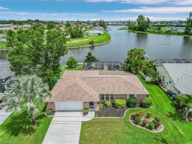 Birds eye view of property with a water view