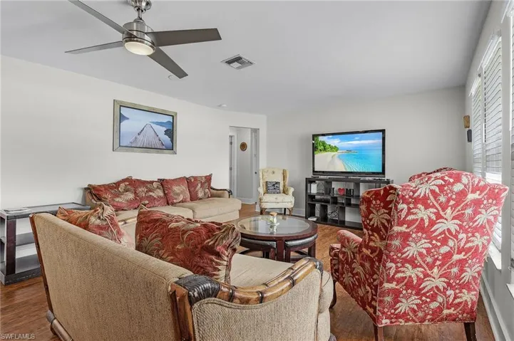 Living room featuring wood-type flooring and ceiling fan