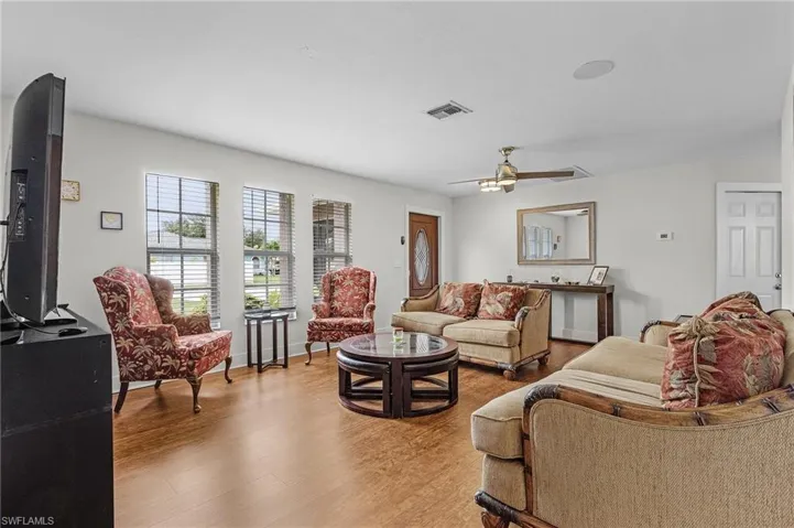 Living room featuring ceiling fan and wood-type flooring