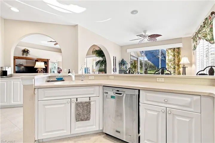 White cabinetry with neutral countertops and stainless steel dishwasher