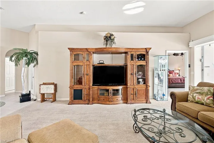 Archway entry leading to a white paneled door