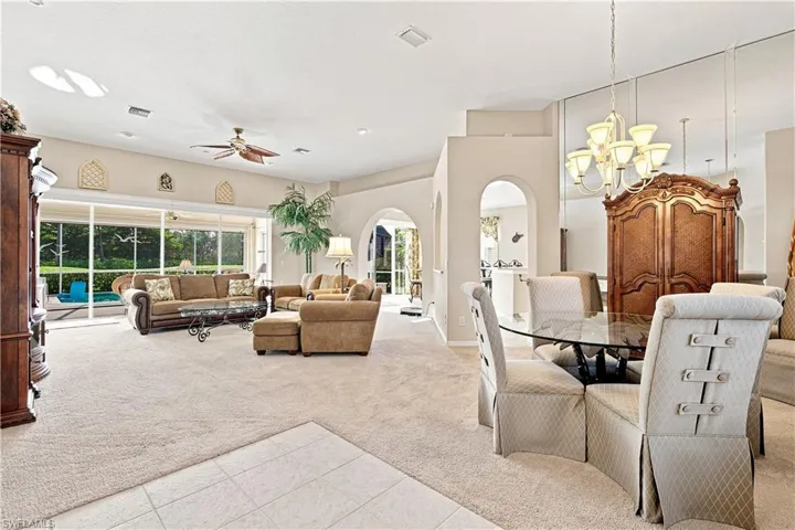 Entry into home  with high ceilings, recessed lighting, arched doorways, and large sliding glass doors
