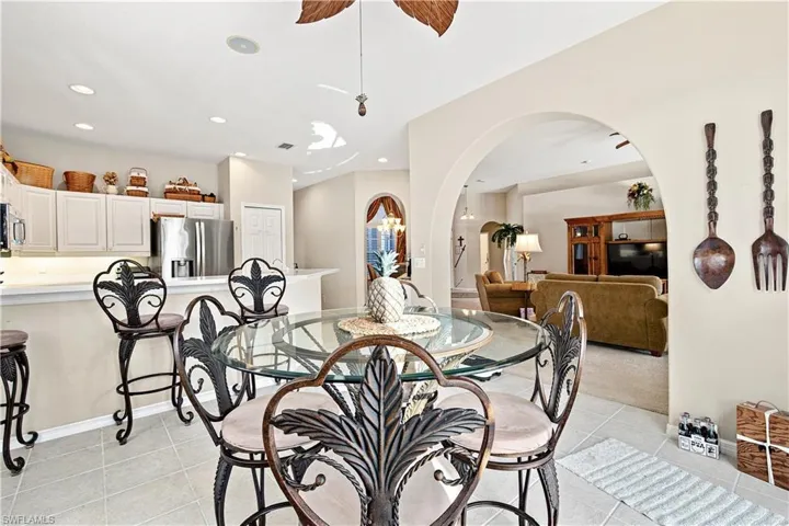 Kitchen with white upper cabinetry and a stainless steel refrigerator