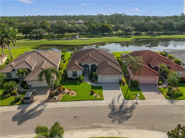 Mediterranean-style single-story residence with a tile roof, paver driveway, and an attached two-car garage