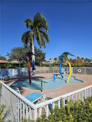 Community pool featuring a water play area and a patio area