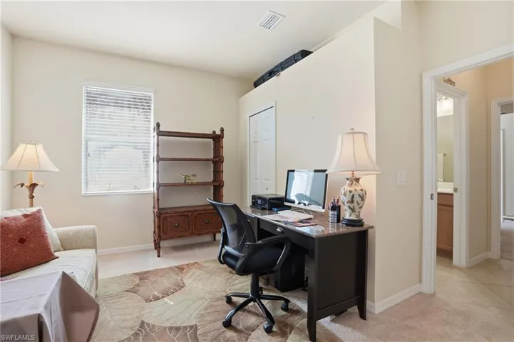 Office space with light colored carpet and baseboards