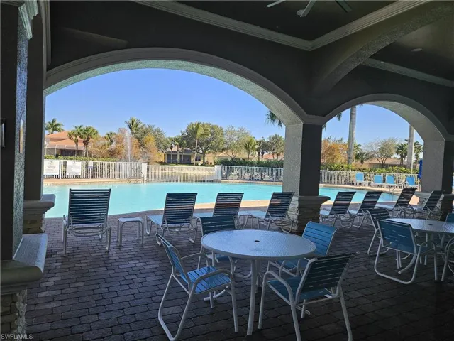 View of patio / terrace featuring ceiling fan, outdoor dining space, and a community pool