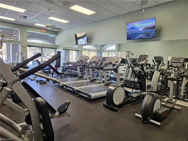 Workout area with a paneled ceiling and a ceiling fan