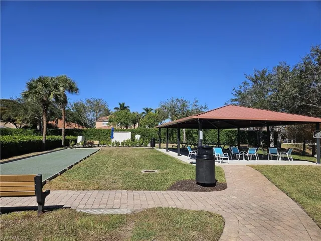 Surrounding community featuring a patio and a game area