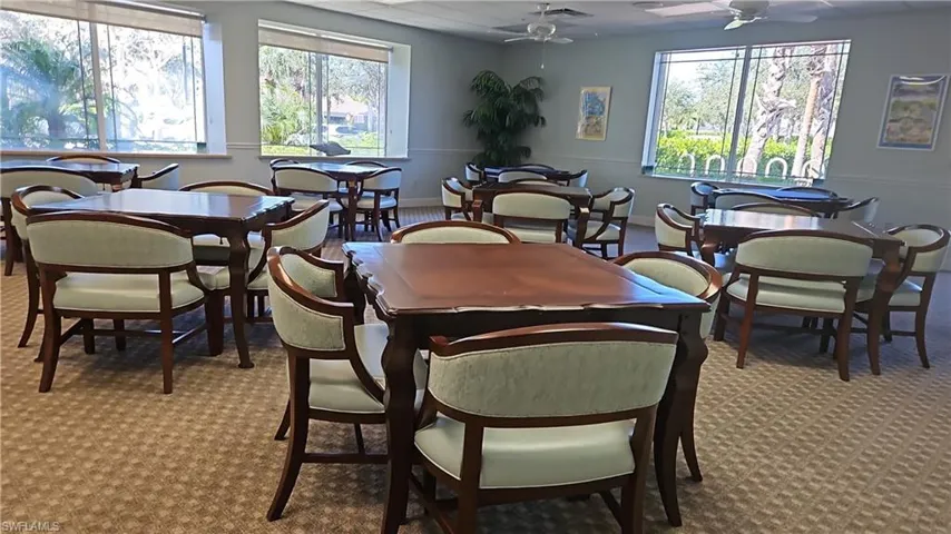Dining area with a ceiling fan and carpet floors