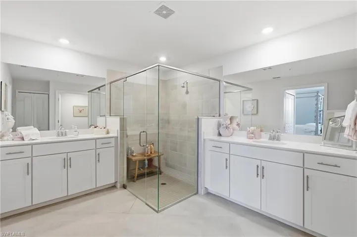 Spacious bathroom featuring a glass-enclosed shower with tiled walls and a tiled floor