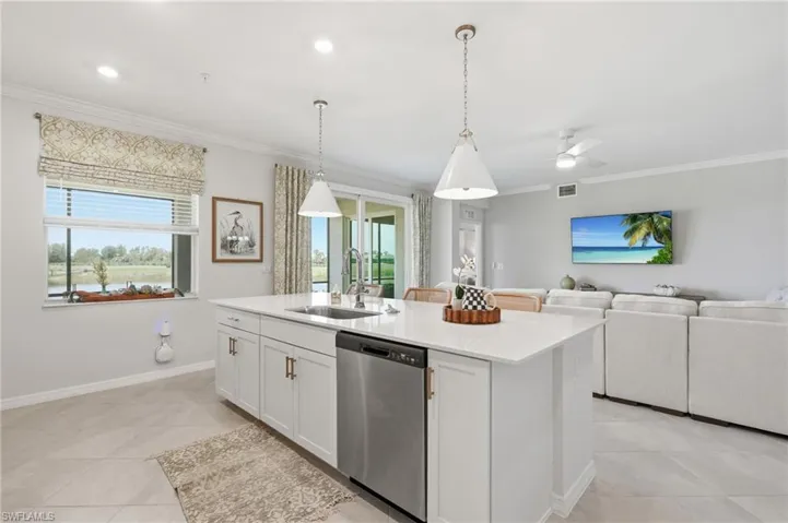 Spacious kitchen island with an undermount sink and stainless steel dishwasher