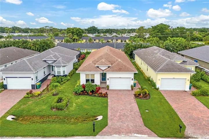 View of front of house with a garage and a front lawn