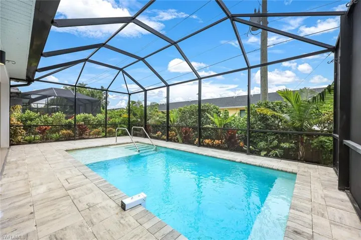 View of pool with a patio and a lanai