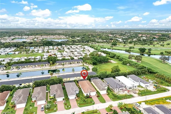 Birds eye view of property with a water view