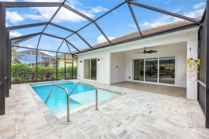 View of swimming pool featuring a lanai and a patio area