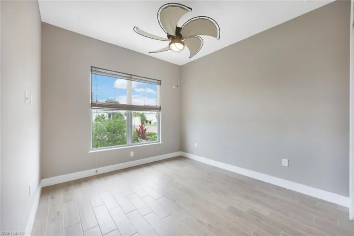 Empty room featuring light hardwood / wood-style floors and ceiling fan