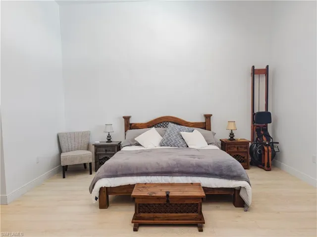 Bedroom featuring light wood finished floors and baseboards