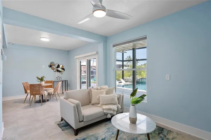 Living area with baseboards and ceiling fan