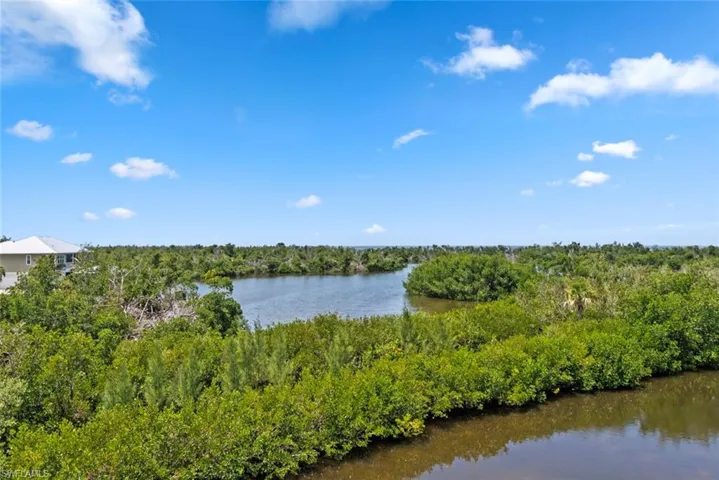 Property view of water with a wooded view