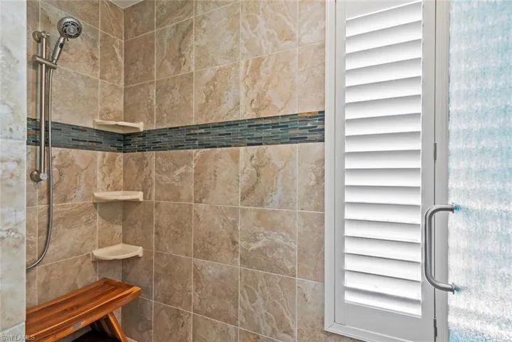 Full bath featuring a tile shower