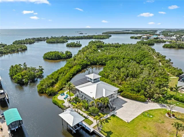 Birds eye view of property with a water view