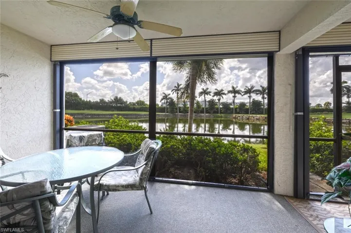 Sunroom / solarium featuring a ceiling fan, a water view, and healthy amount of natural light